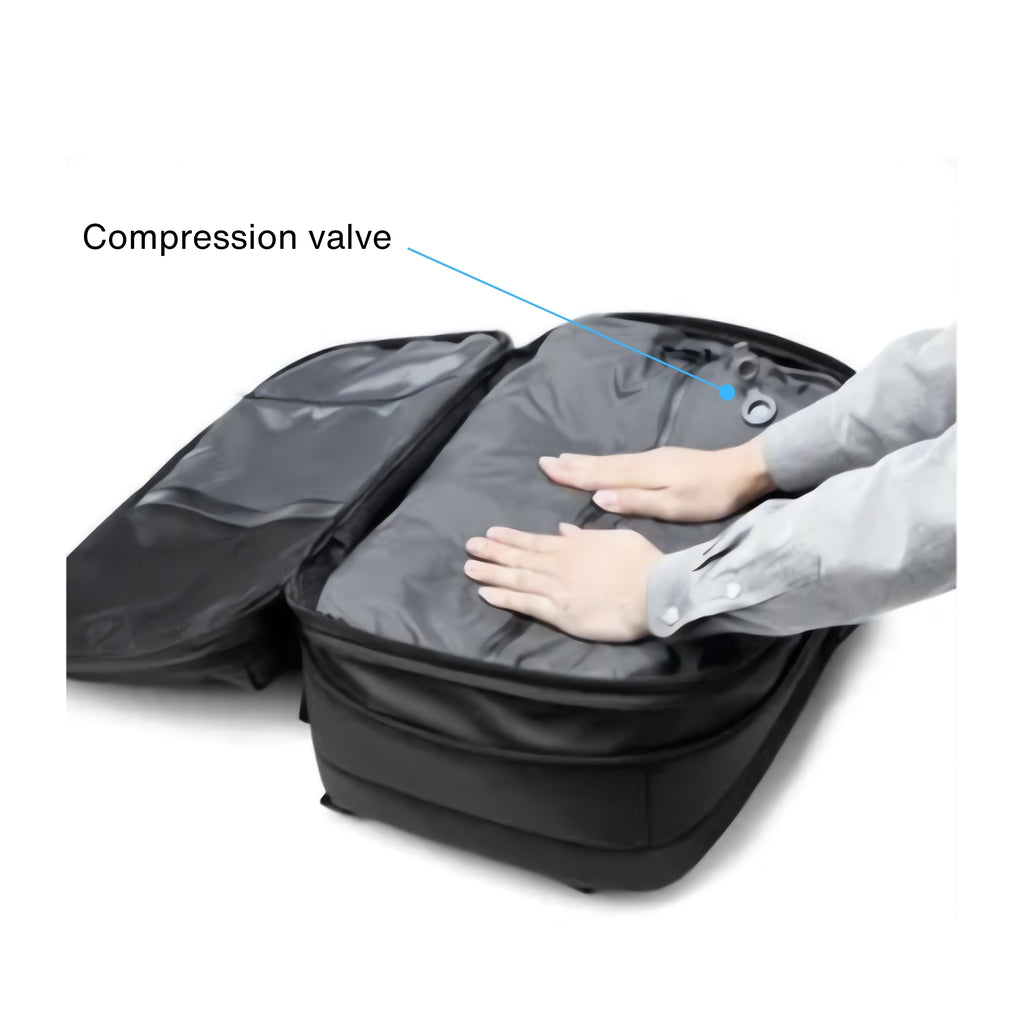 Black suitcase with a compression valve being used, labeled on a white background